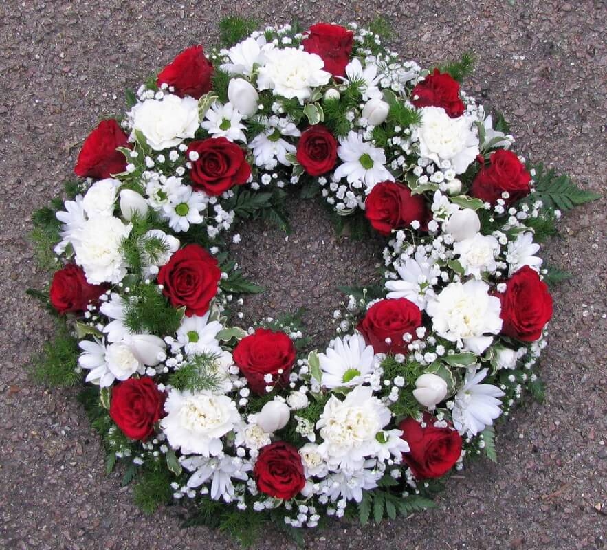 26.  12” traditional wreath in White with Red Roses
