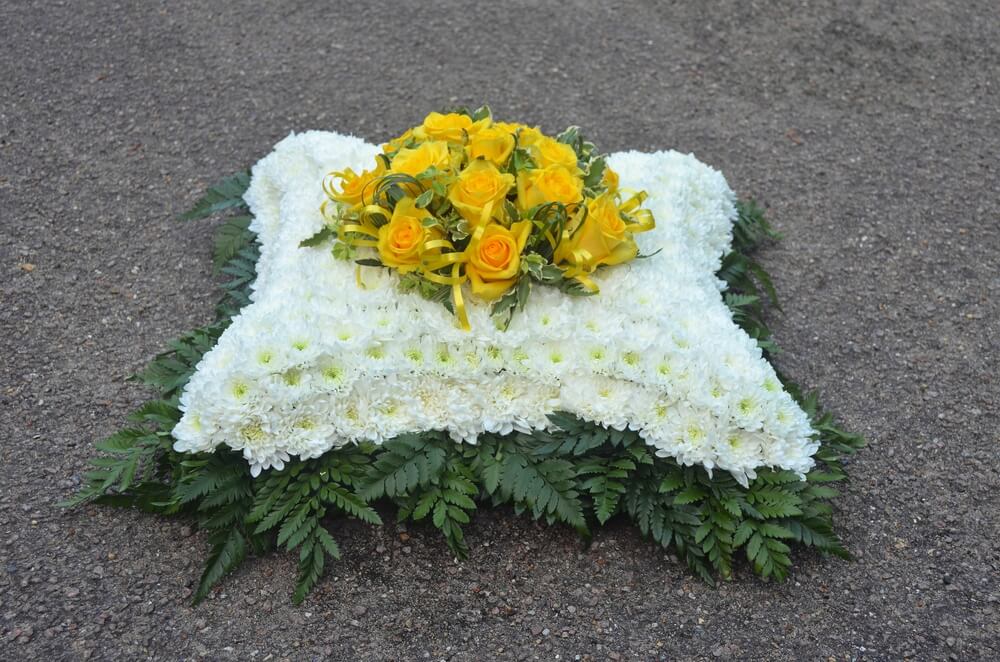2. 15” Cushion in white with foliage edge and posy of yellow Roses to the centre