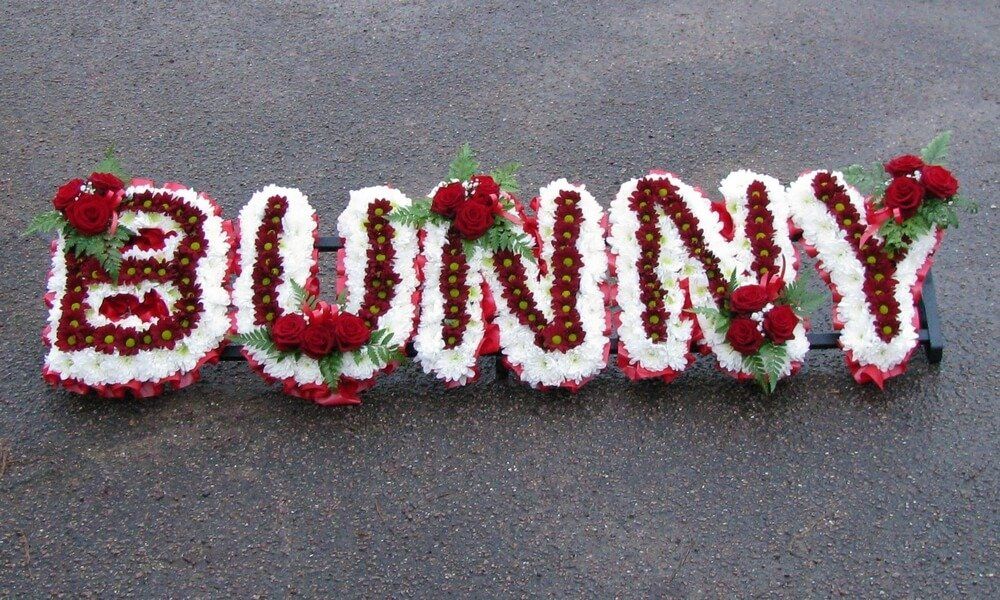 25. White and red letters with red Rose posies