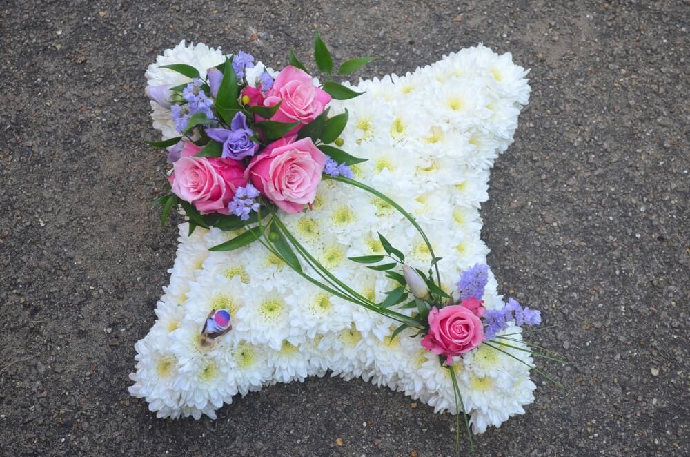 5. 12” White Cushion with pink and lilac posies and small feather bird