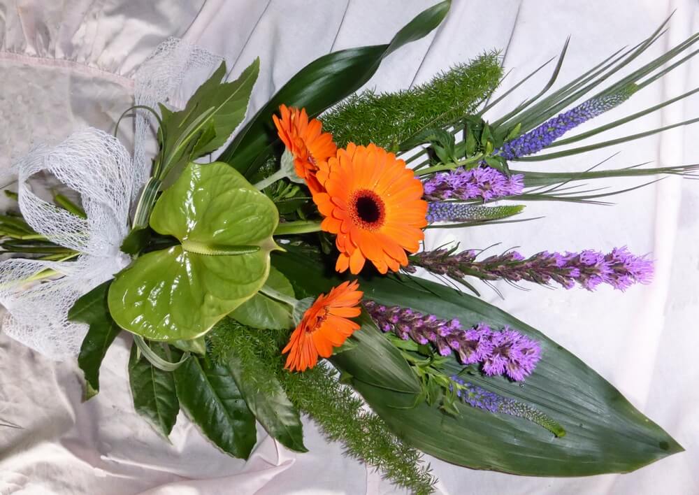 33. Bright sheaf of green Anthurium, orange Germini, purple Veronica and Liatris