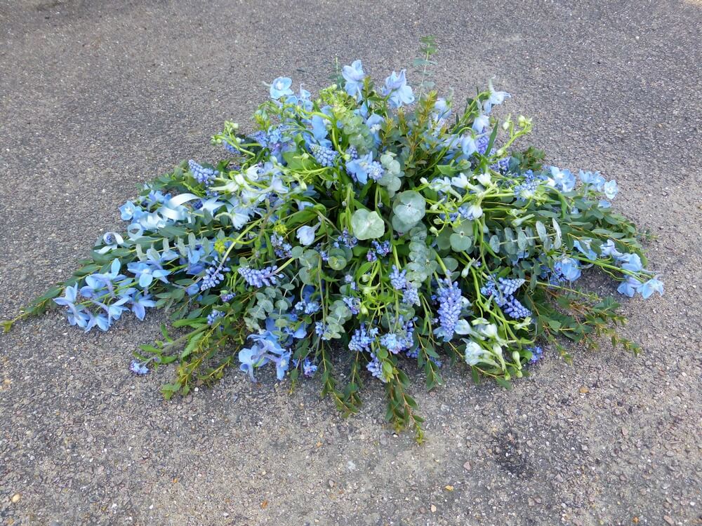42. Beautiful pale blue spray for an Infant including Muscari, Delphinium and Forget Me Knots