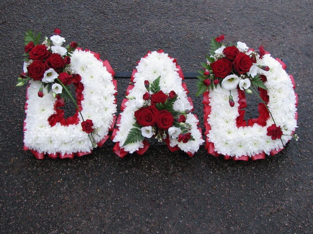 23. DAD with white letters, red Roses and white Lisianthus posies