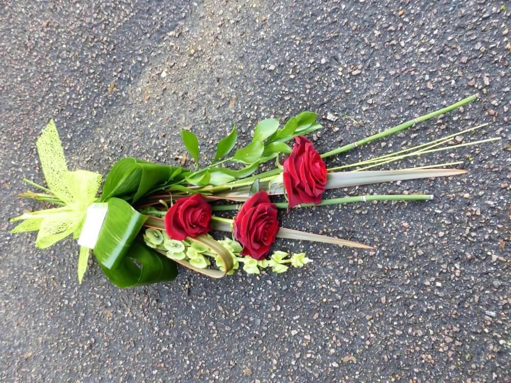 29. Small sheaf of red Roses, Moluccella, Aspidistra, Phormium and Grasses