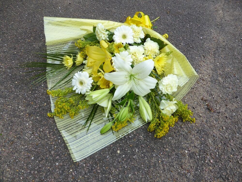 27. Tied sheaf bouquet with yellow and white Lily’s, yellow Golden Rod and Carnations