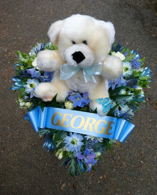 13. Small Heart with blue Nigella, Delphiniums and Thistle. Ribbon sash, butterfly and small Teddy