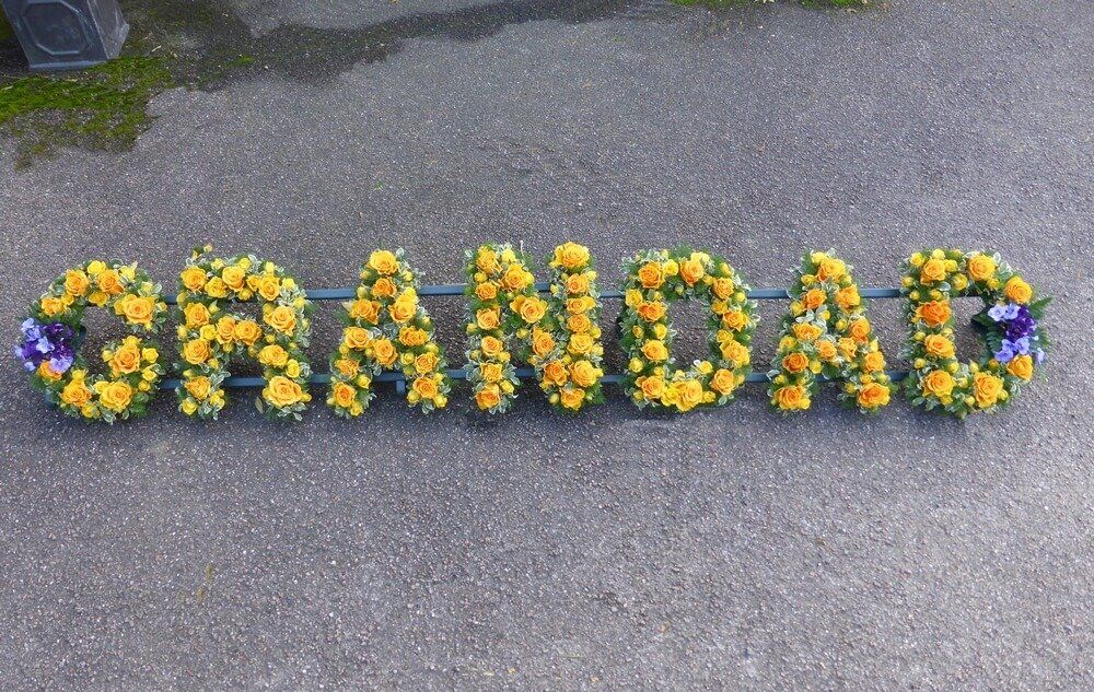 34. GRANDAD with large and spray yellow Roses, small posy of Violets at either end