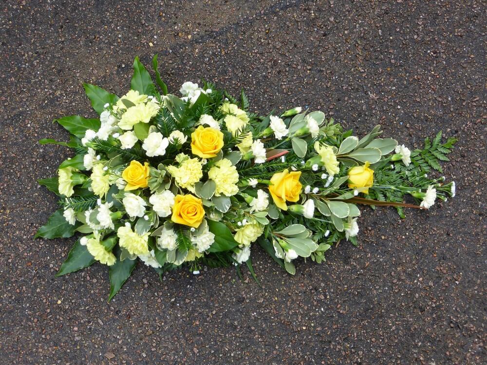 25. Spray in yellow with Carnations, Roses and Dianthus