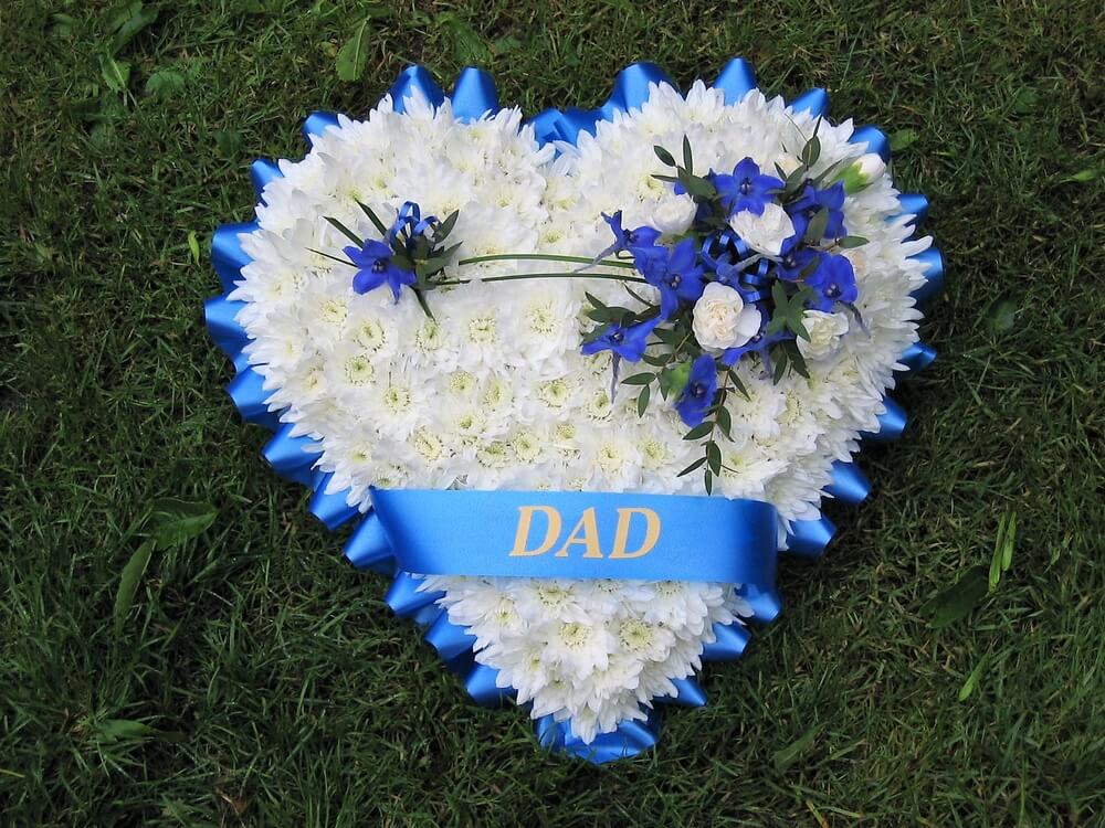 9. White Heart with blue ribbon edge, ribbon sash, posy of Delphiniums and Dianthus