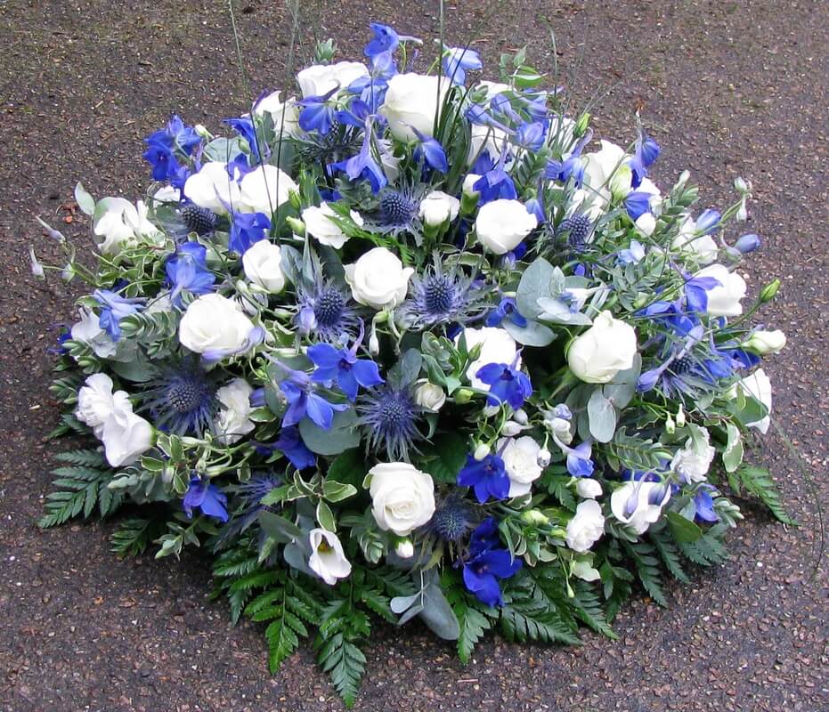 18.  12” Posy with blue Thistle, Delphiniums and white Rosebuds