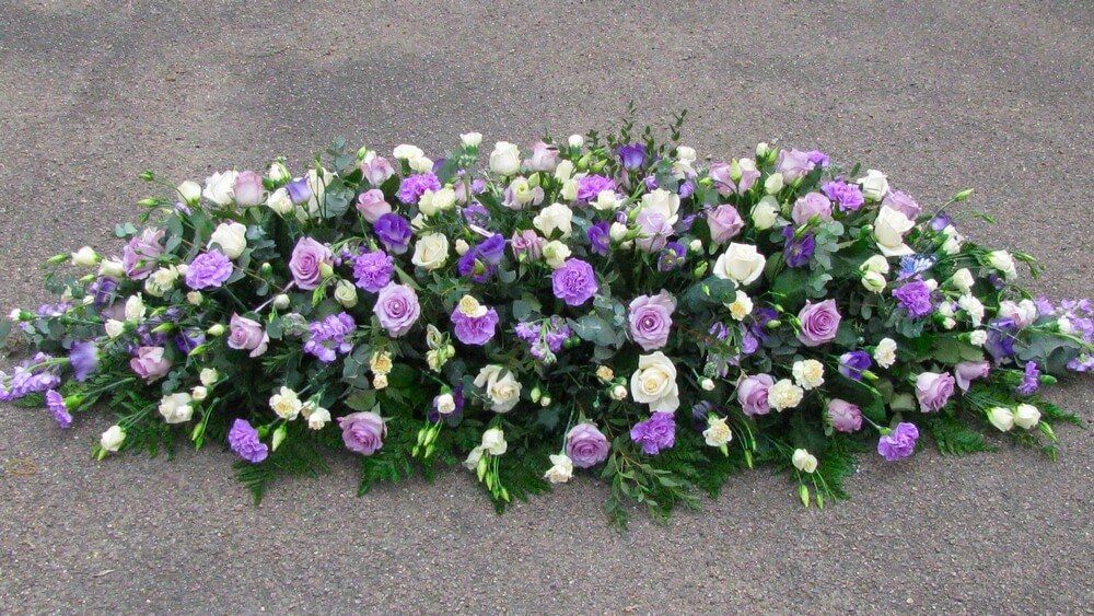 31. Full coffin spray with lilac Roses, Carnations, Stocks and Lisianthus. Cream Roses and Dianthus