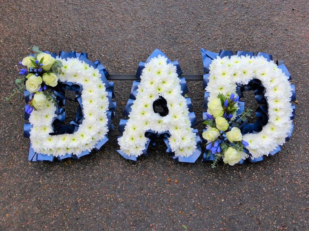 12. White letters with posies of white Roses and blue Gentianas