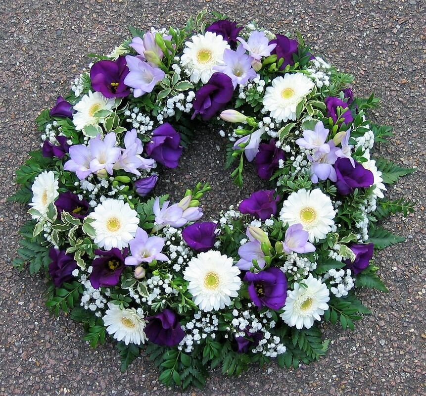 17.  12” wreath with purple Lisianthus, lilac Freesia and white Germini