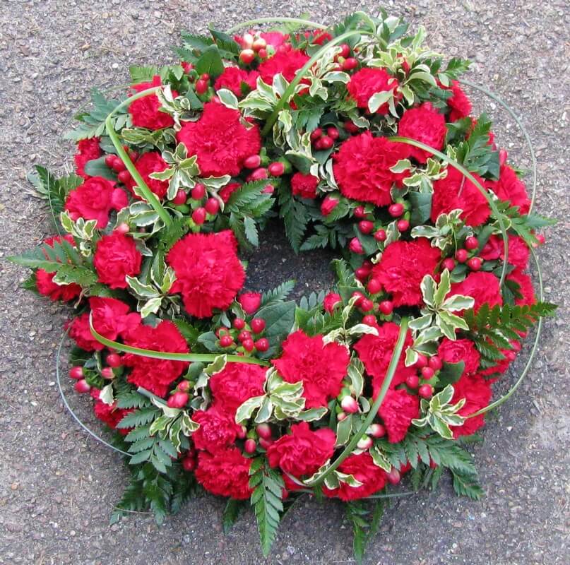 13.  12” red Carnation and Berry wreath