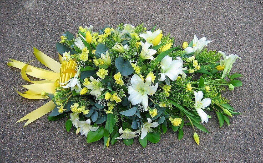 19. Spray of white Lily’s with yellow Narcissus, Tulips and Golden Rod.