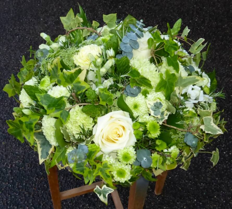 38.  12” green, cream and white wreath
