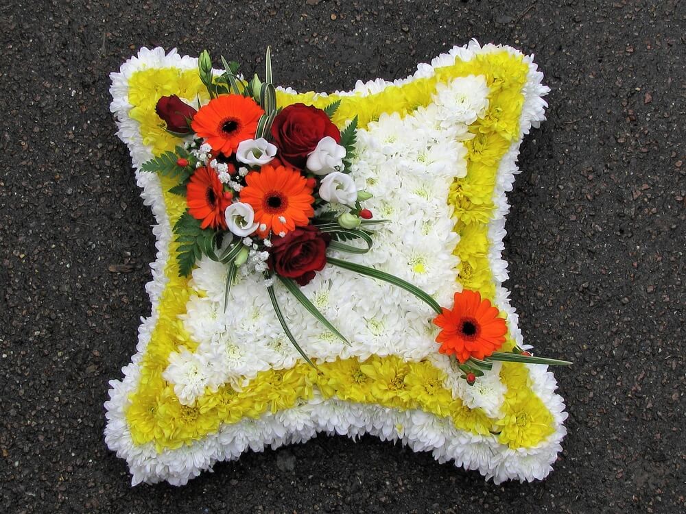 10. 15” Cushion with yellow and white background, posy of red Rose, orange Germini and white Lisianthus