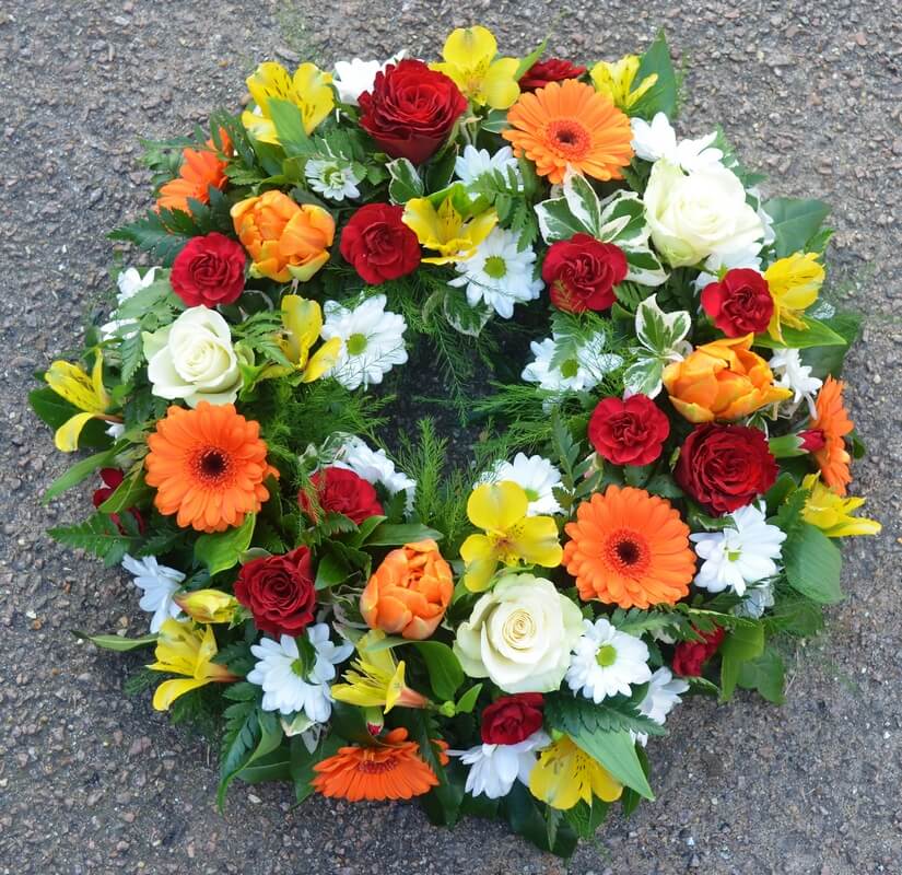 8.   14” colourful wreath with Roses, Dianthus, Germini and Tulips