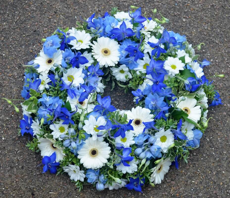 7.   12” blue Delphinium and white Germini wreath