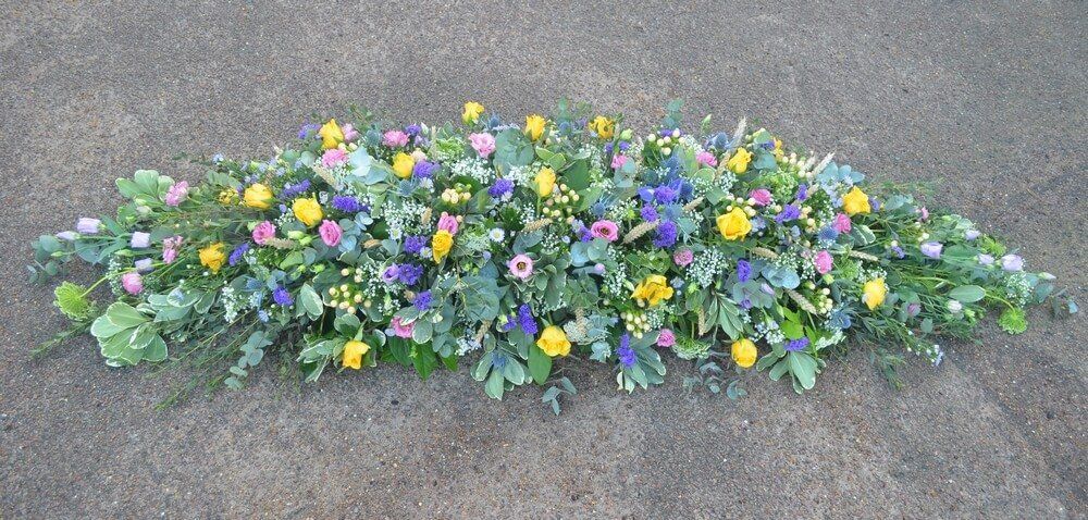 21. Full coffin spray with Roses, Lisianthus, Berries, Thistles, Statice and Ammis