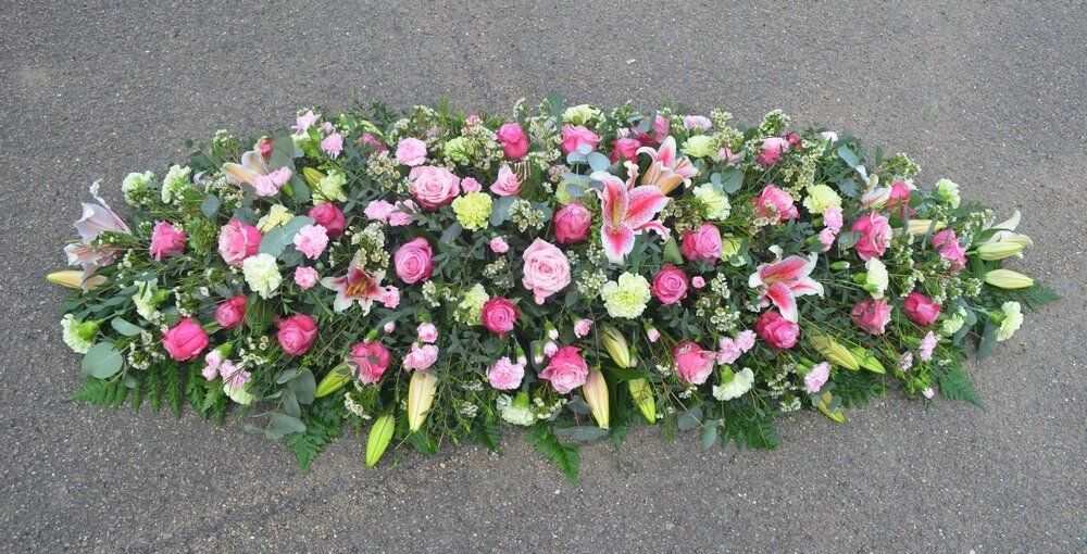 18. Full Coffin Spray of pink Lily’s, Roses and Dianthus with green bloom Carnations and Waxflowers