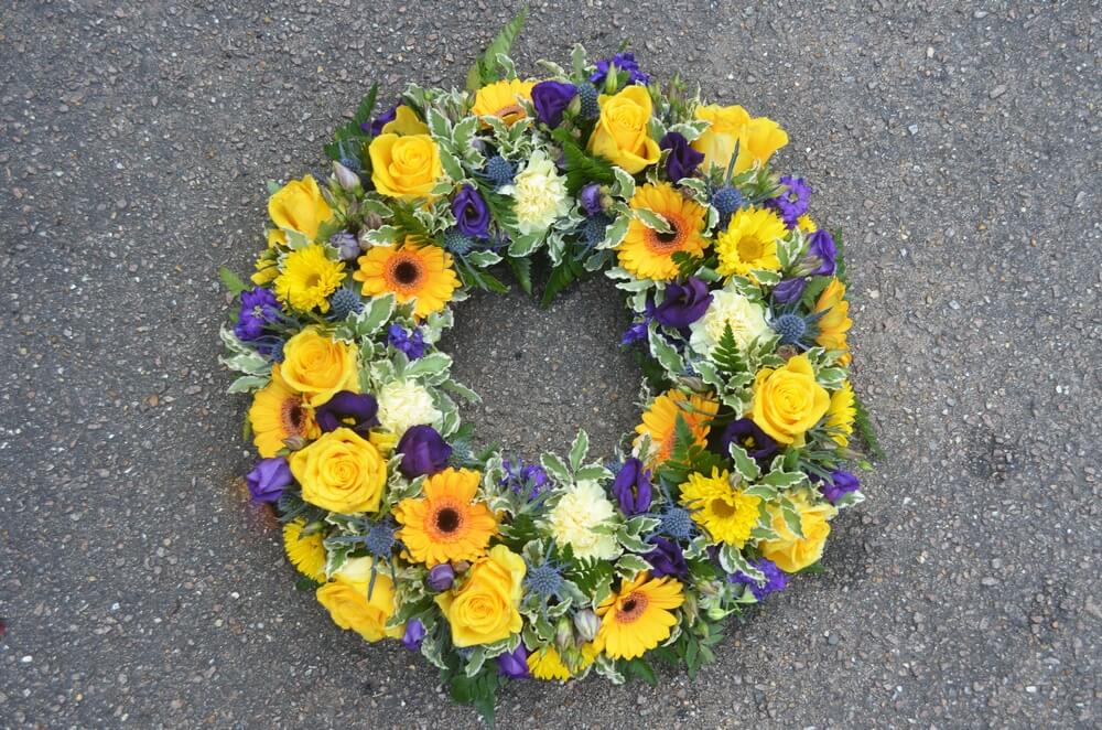 2.  14” purple Lisianthus, yellow Roses and Germini wreath