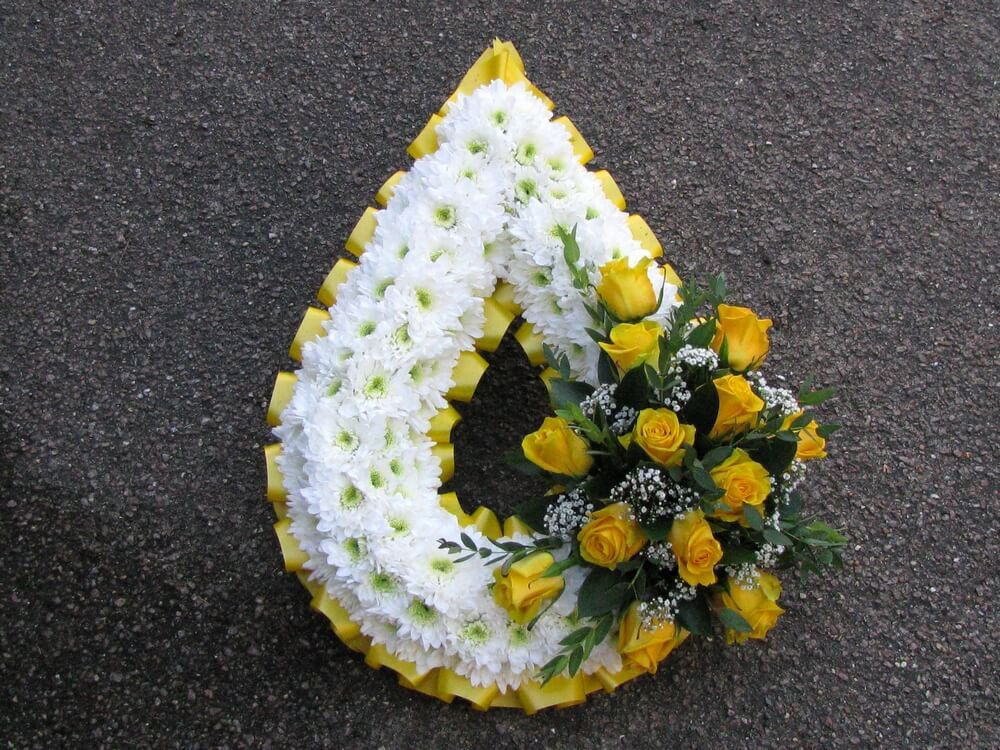 12. Teardrop in white with yellow ribbon edge and posy of yellow Roses