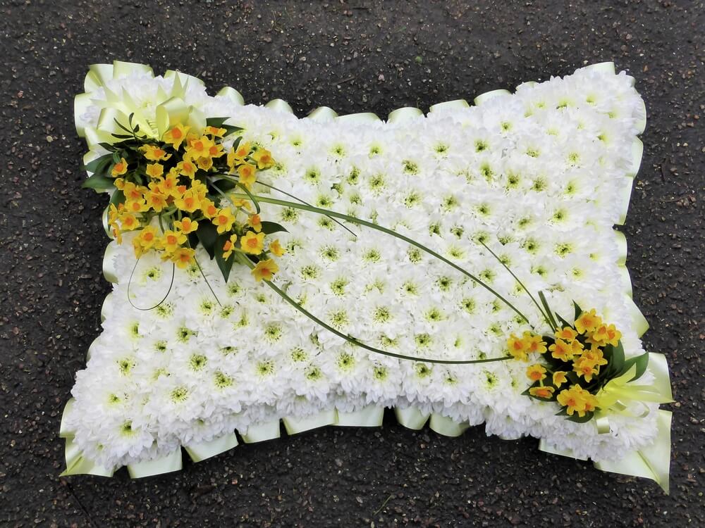12. 21” white Pillow with cream ribbon edge and posies of yellow and orange Narcissus