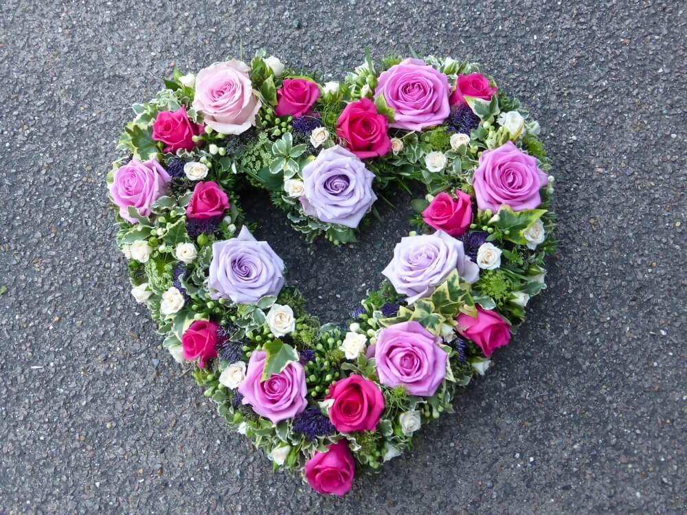 27. Hollow Heart with lilac, cerise and pale pink Roses, cream Rosebuds, purple Trachelium and Bouvardia