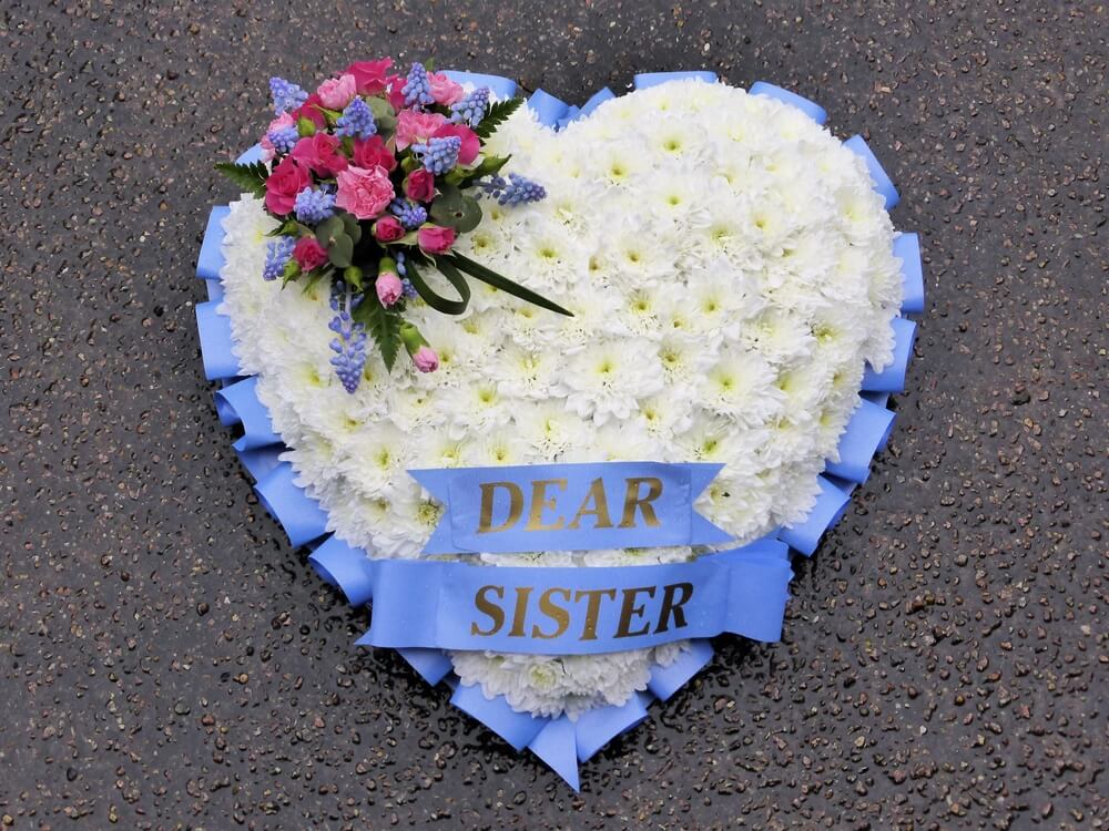 21. White Heart with pale blue ribbon edge and sash, posy of pink and blue flowers