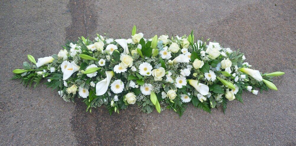 47. Full coffin spray in white with Arum and Longiflorum Lily’s, Germini, Roses, Lisianthus and Gypsophila