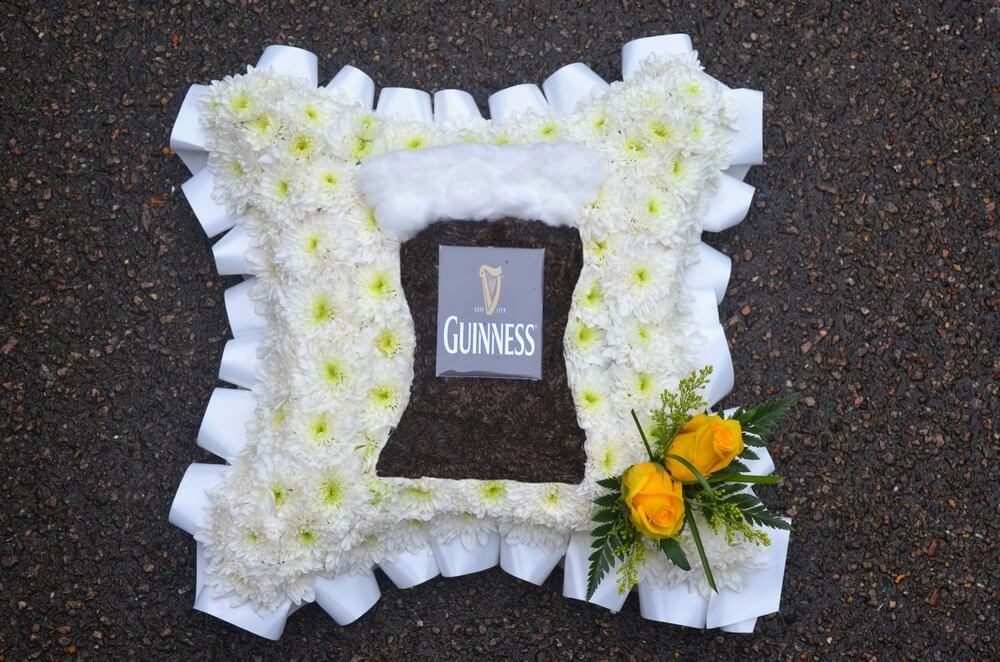 9. 12” white Cushion with custom made Guinness Glass to the centre, white ribbon edge and yellow Rose posy