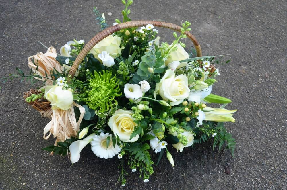 7.  Basket of green and white Flowers with Raffia