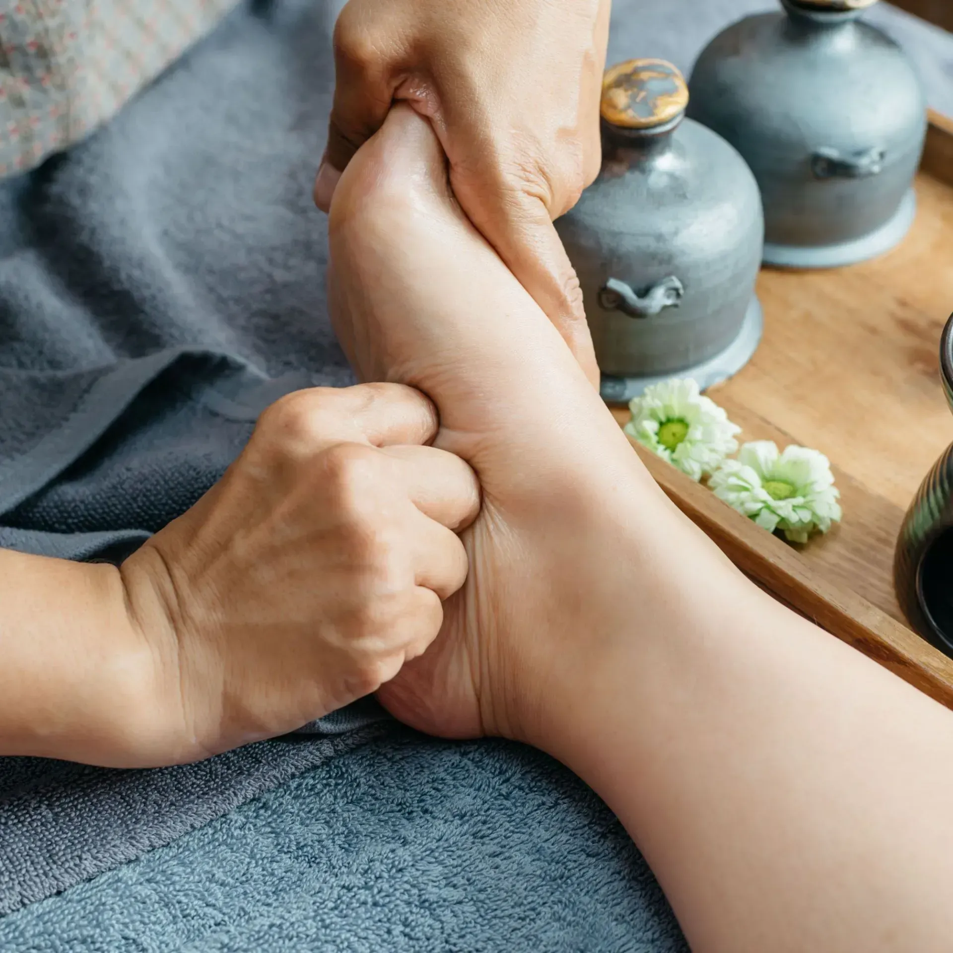 A person is giving a foot massage to another person.