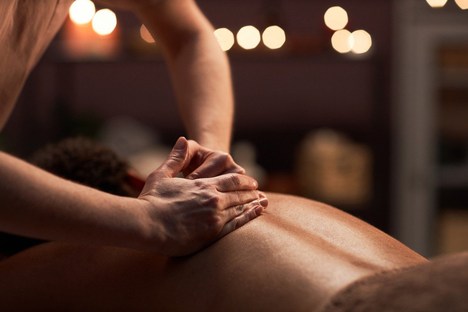 A woman is giving a man a massage in a spa.