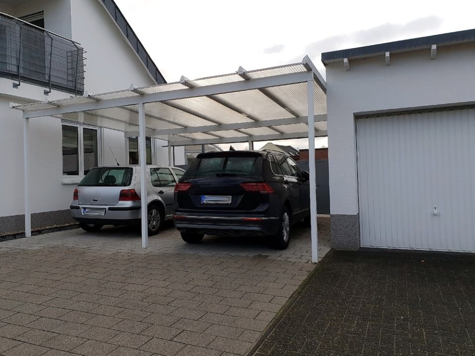Two Cars Are Parked Under a Canopy in Front of a Garage — All Clean Pressure Cleaning in Charlestown, NSW
