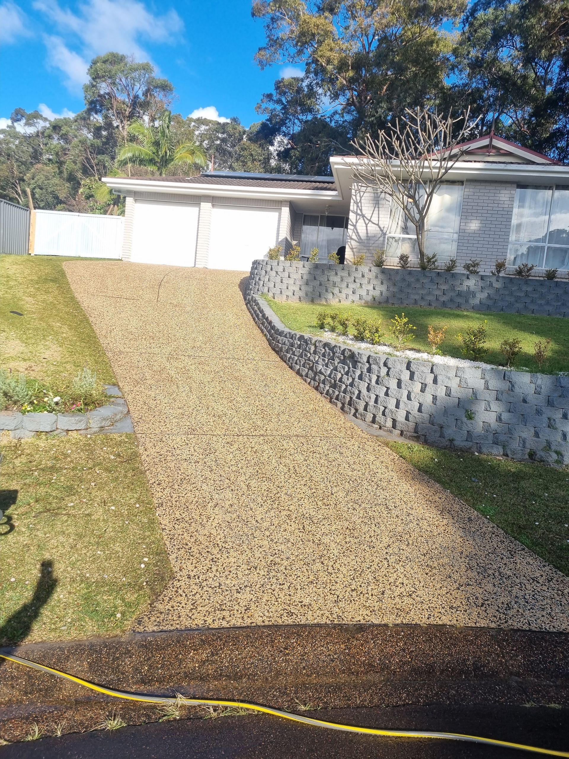 A Gravel Driveway Leading to a House on a Hill — All Clean Pressure Cleaning in Valentine, NSW