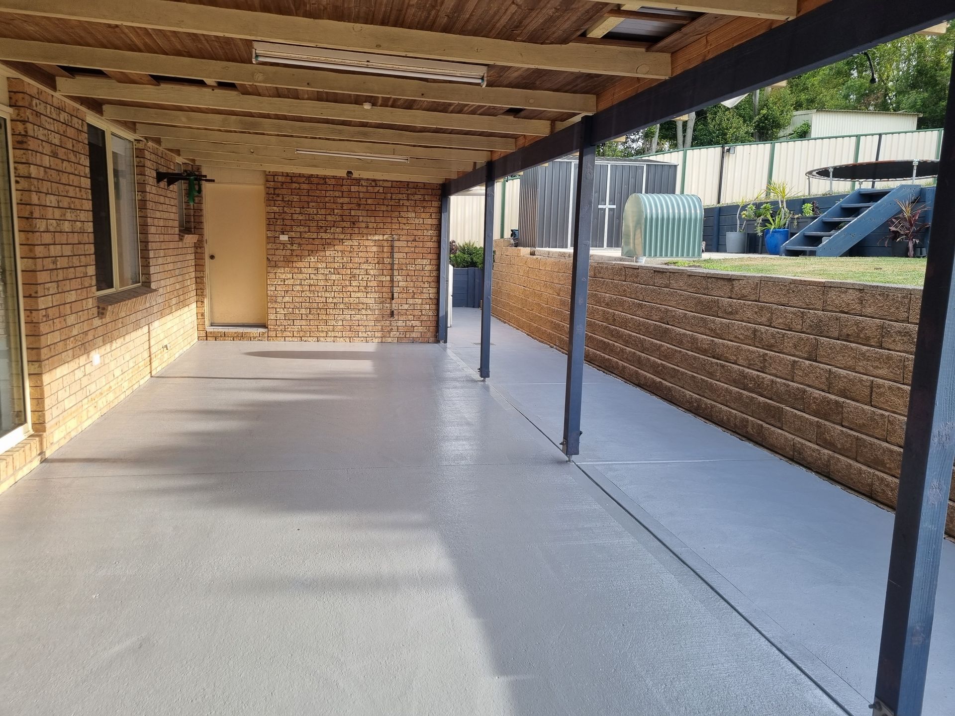 A Large Covered Patio With a Brick Wall in the Background — All Clean Pressure Cleaning in Valentine, NSW