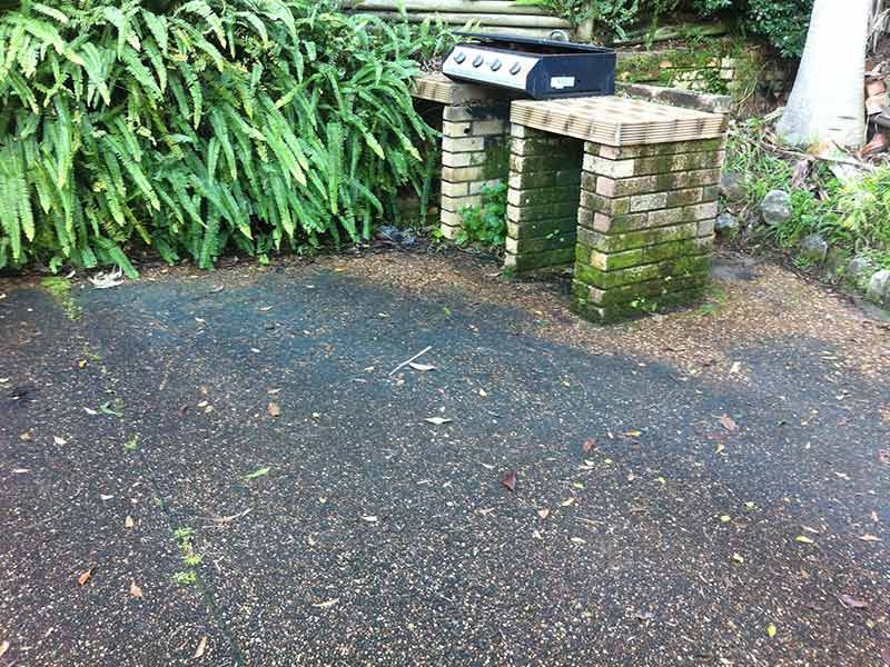 A Grill is Sitting on Top of a Brick Patio Next to a Brick Wall — All Clean Pressure Cleaning in Valentine, NSW
