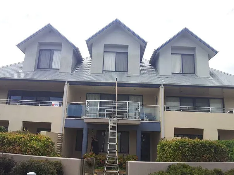 A Ladder is Attached to the Side of a Building — All Clean Pressure Cleaning in Valentine, NSW