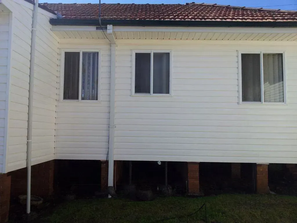 The Back of a White House With a Red Tile Roof — All Clean Pressure Cleaning in Valentine, NSW