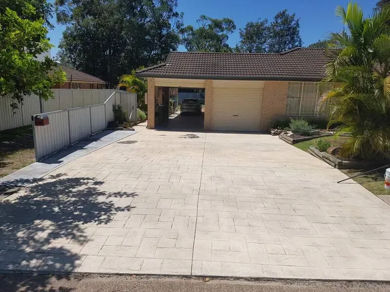 A Car is Parked in a Driveway in Front of a House — All Clean Pressure Cleaning in Valentine, NSW