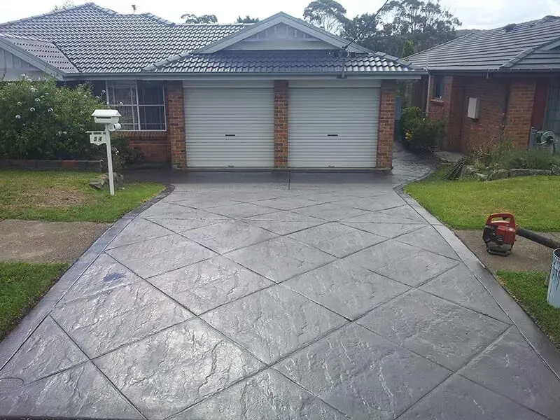 A Driveway Leading to a House With Two Garage Doors — All Clean Pressure Cleaning in Valentine, NSW