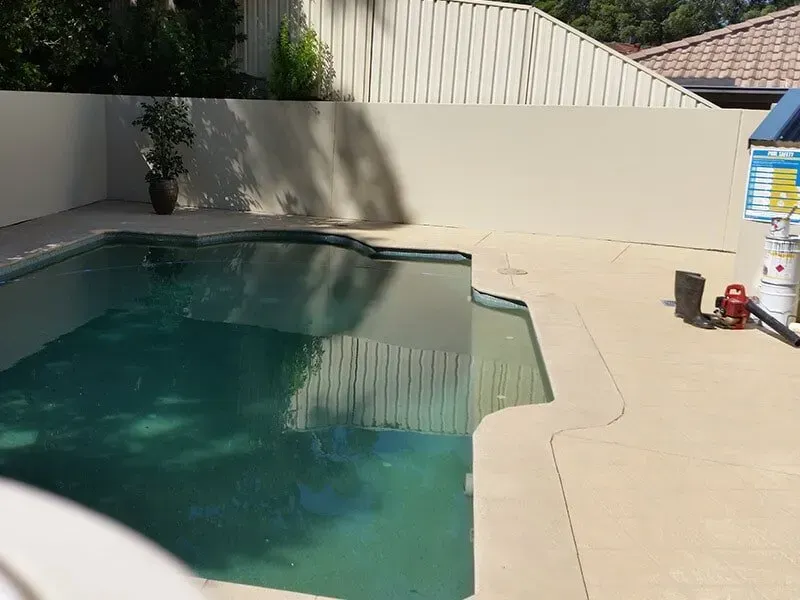 A Swimming Pool With a White Fence Surrounding It — All Clean Pressure Cleaning in Valentine, NSW