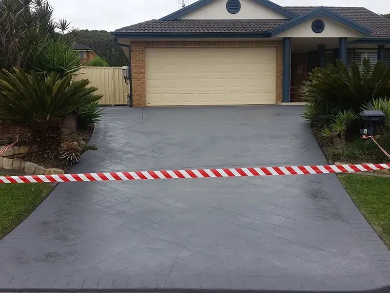 A Driveway With a Red and White Tape Blocking It in Front of a House — All Clean Pressure Cleaning in Valentine, NSW