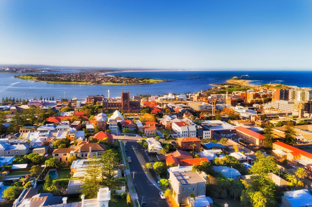 An Aerial View of a City With a Large Body of Water in the Background — All Clean Pressure Cleaning in Newcastle, NSW