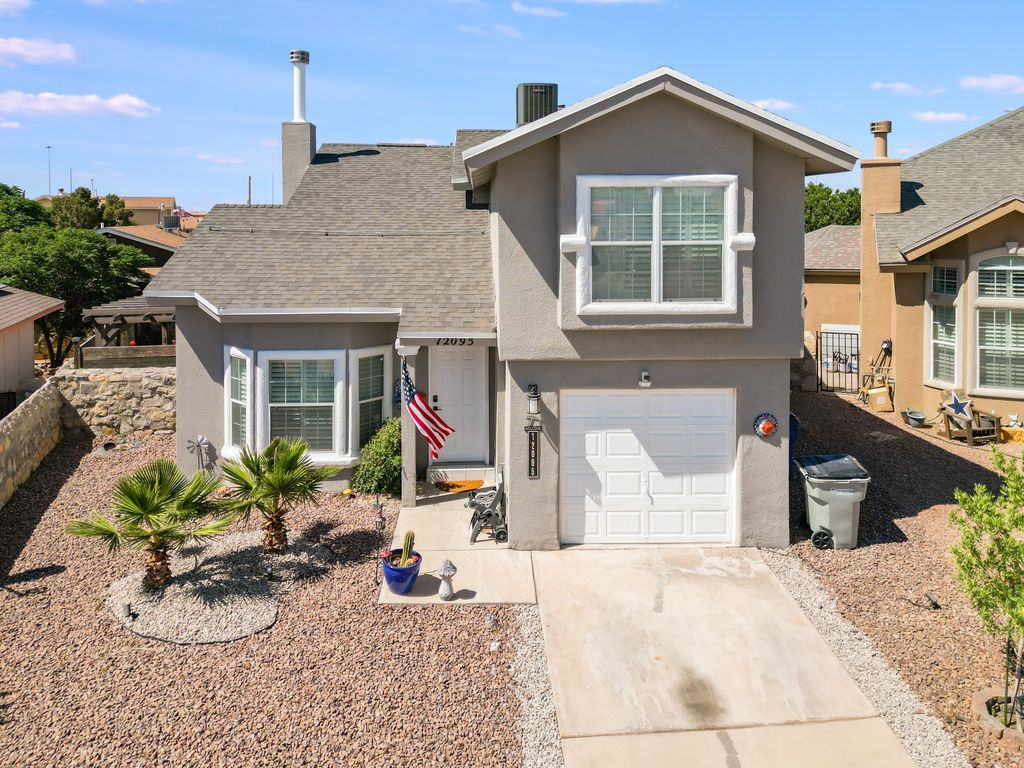 An aerial view of a house with a white garage door
