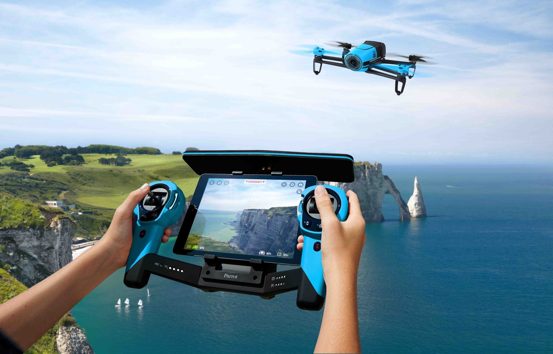 Drone pilot holding a drone and remote controller during setup for an aerial shoot.