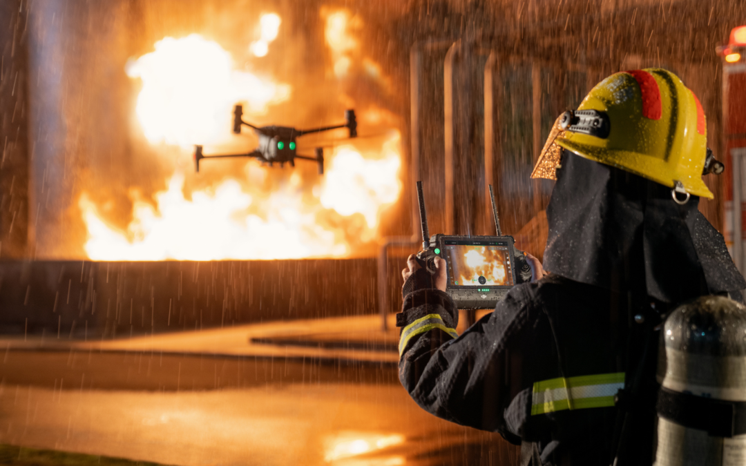 Firefighter using a UAS to assess fire hazards and scene during active firefighting operations.