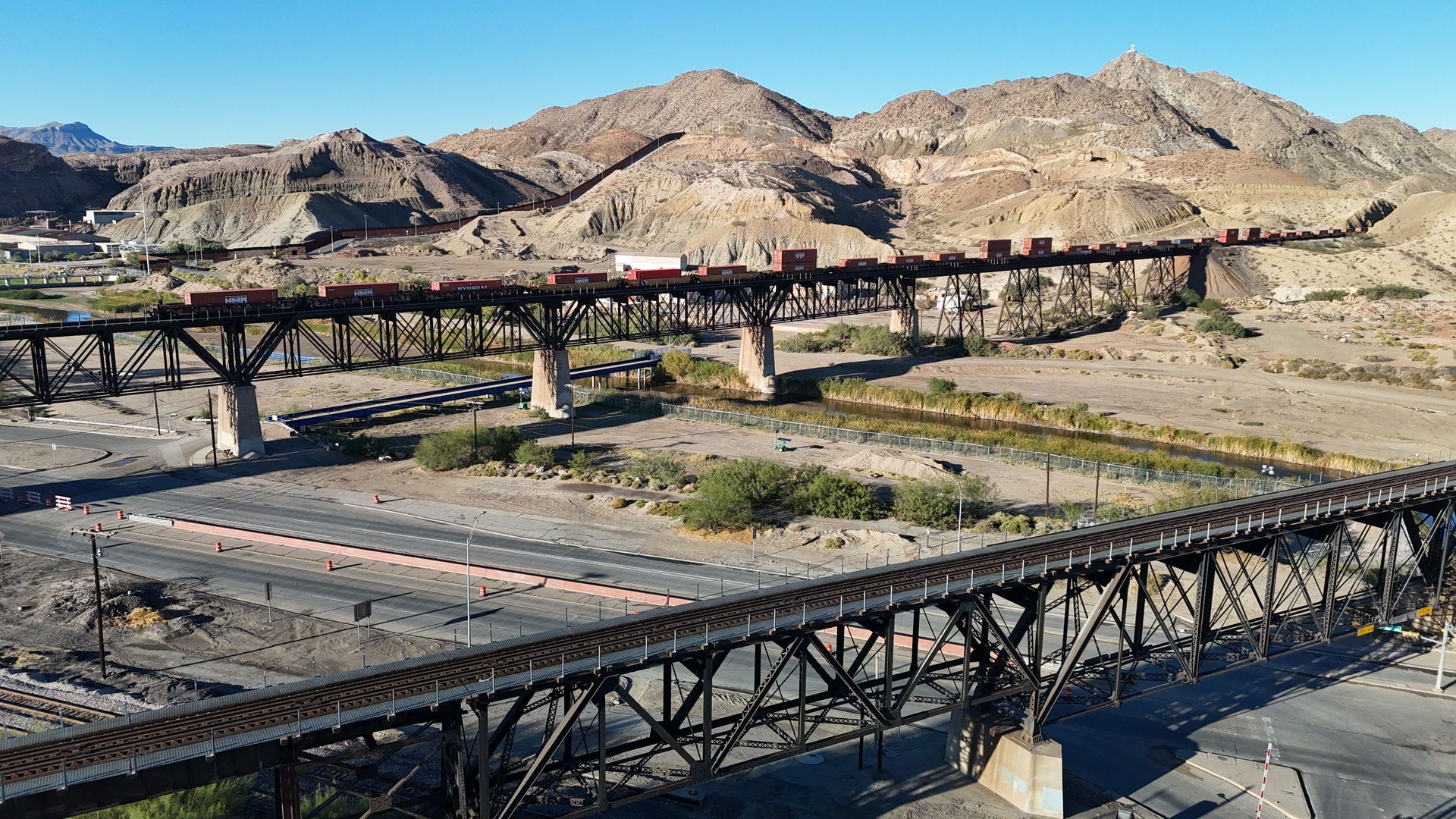 Union Pacific railroad bridge in El Paso, TX, spanning a desert landscape with tracks and industrial surroundings